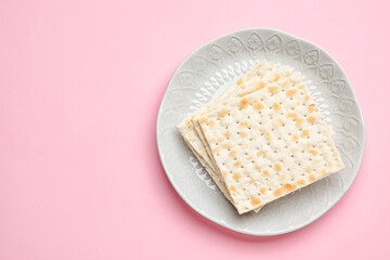 Plate with Jewish flatbread for Passover on color background
