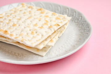 Plate with Jewish flatbread for Passover on color background, closeup