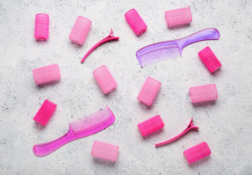 Pink Hair Curlers With Combs And Clips On Grunge Background