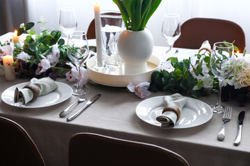 Stylish table setting with beautiful flowers in dining room