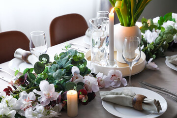 Stylish table setting with beautiful flowers in dining room