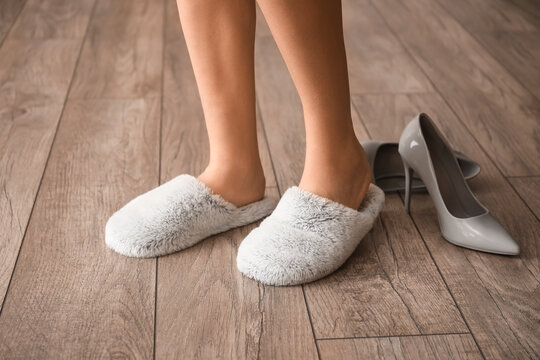 Young woman at home after changing high heels for soft slippers