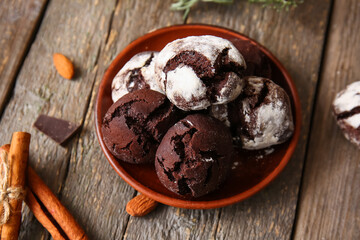 Plate of chocolate brownie cookies on wooden background