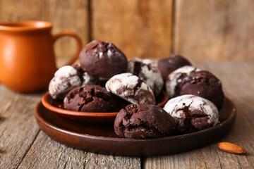 Plates of chocolate brownie cookies on wooden background