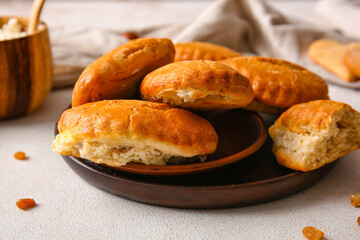 Plate of tasty sochniki with cottage cheese on light background