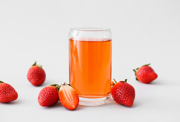Glass of fresh strawberry kombucha on light background, closeup