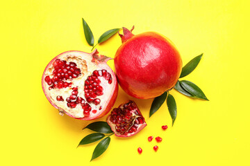 Ripe delicious pomegranate on yellow background