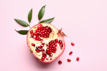 Ripe delicious pomegranate on pink background