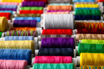 Set of spools with colorful sewing threads, closeup