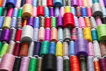 Set of spools with different colorful sewing threads