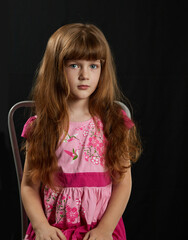 Little girl on a black background