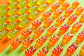 Yummy jelly bears on color background, closeup