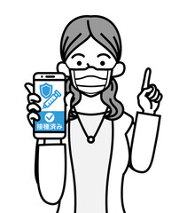 ワクチン接種証明の画面を表示したスマホを持ち、指を差す若い女性 - マスク着用