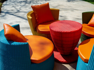 Empty modern colorful rattan furniture, outdoor garden weave table set with round table and four...