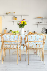 Vase with beautiful Chrysanthemum flowers on dining table in kitchen