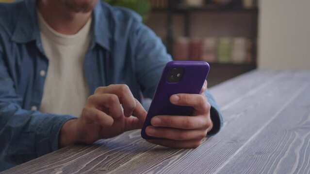 A handsome man is typing something on the phone