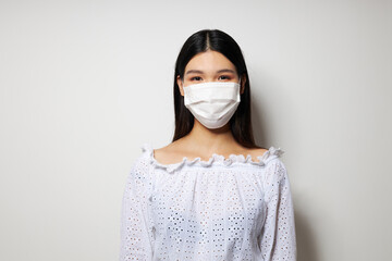 woman medical mask on the head protection light background unaltered