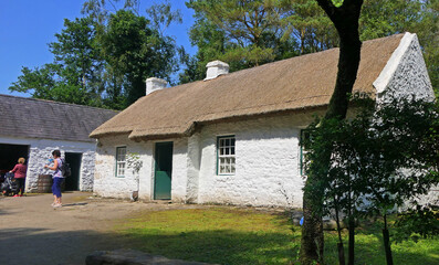 Old Irish Traditional Whitewashed Cottage with a thatched roof at The Ulster America Folk Park...