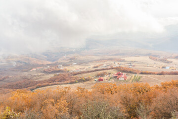 Village in the valley through the fog