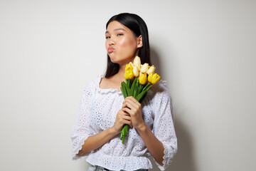 Portrait Asian beautiful young woman romance bouquet of flowers near the face studio model unaltered