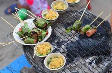 Snacks cooking on a coal stove on the side of the street in Binh Hung Island, Nha Trang, Vietnam