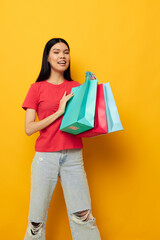 Portrait Asian beautiful young woman with colorful bags posing shopping fun studio model unaltered