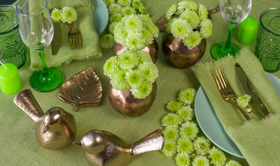 Festive spring table setting with flowers in green tone