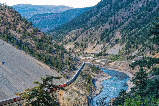 A southbound train runs along the west side of the Fraser River in British Columbia, Canada