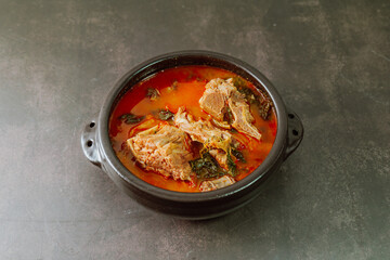 Gamjatang, Korean style Pork Back-bone Stew : A thick soup made of pig backbones, potato, green cabbage leaves (ugeoji), crushed perilla seeds, perilla leaves, spring onions, and garlic. A spicy dish 
