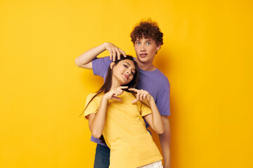 Obraz premium young boy and girl in colorful t-shirts posing friendship fun Lifestyle unaltered