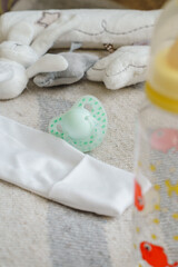 newborn clothing and feeding bottle with pacifier