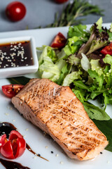 Grilled Salmon fish steak with fresh vegetables salad, Healthy salad for keto diet, friendly salmon with vegetables diet dish. Paleo, keto Diet