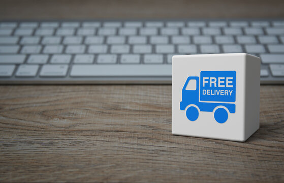 Free delivery truck flat icon on white block cube with modern computer keyboard on wooden table, Business transportation online concept