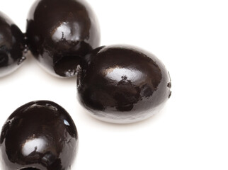 Black olives isolated on a white background.