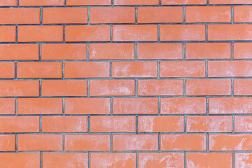 Salt on the red brick wall of the house as a background.