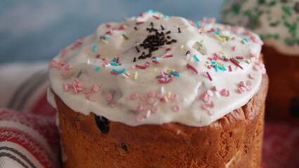 Close up Rustic baked traditional Easter cake for orthodox Easter. Cupcakes with white icing and colored sprinkles on a blue wood background. Romantic wedding national dessert