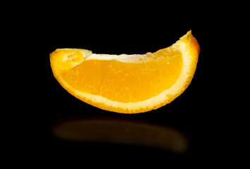 A slice of orange on a black background.