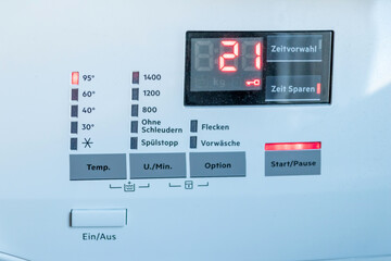 Detail view of washing machine control panel with contemporary thermostat and program selection to...