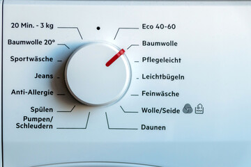 Detail view of washing machine control panel with contemporary thermostat and program selection to switch between different programs for laundry cleaning in modern household for housekeepers hygiene