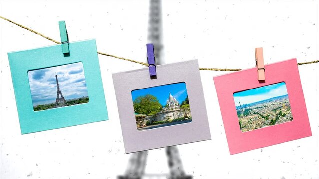 The main sights of Paris in summer in funny frames on a rope with clothespins against the backdrop of the panorama of Paris with the Eiffel Tower in winter.	Creative slow motion 4k parallax video. 