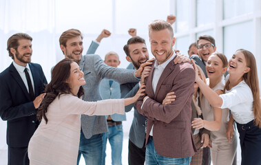 young businessman on the background of applauding business team.