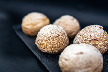 Appetizing Shu cakes on a black background.