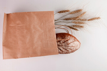 Fresh beautiful bread and wheat spikelets on a white background