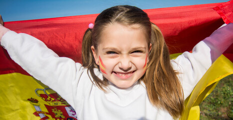 Fan child With Spanish Flag Painted On His Face. Spanish Little Girl With Spain Flag. Fan Of The Olympic Games
