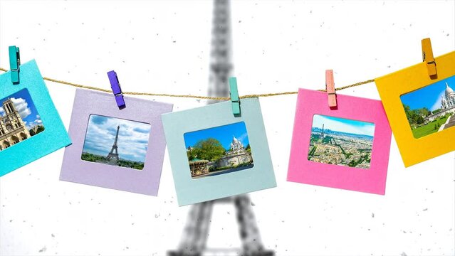 The main sights of Paris in summer in funny frames on a rope with clothespins against the backdrop of the panorama of Paris with the Eiffel Tower in winter.	Creative slow motion 4k parallax video. 