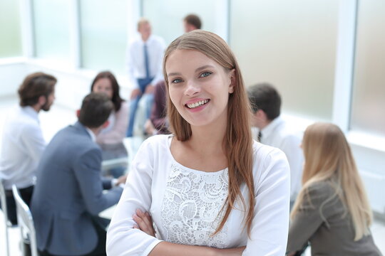 smiling young employee standing in business office.