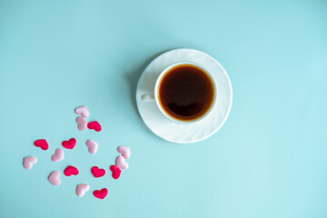 Valentine's blue background concept with coffee cup and hearts