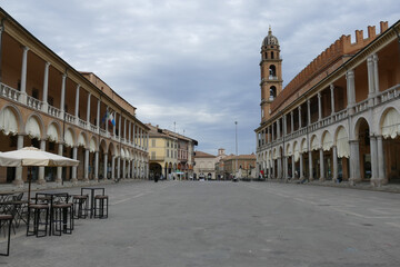 Fototapeta premium piazza del popolo in Faenza surrounded by palaces with arcades and the cathedral and the tower in the background