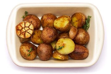 Baked potato in baking dish isolated on white background