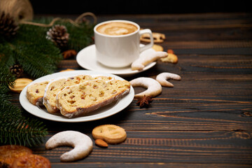 Sliced Traditional Christmas stollen cake with marzipan and dried fruit with New Year decorations